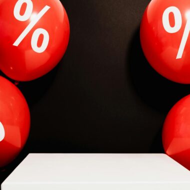 Red balloons marked with percentage symbols on black background, perfect for sales promotions.